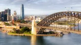 Waterfront architectural landmarks of Sydney city CBD around Circular Quay and The Rocks on the shores of Harbour in aerial cityscape.