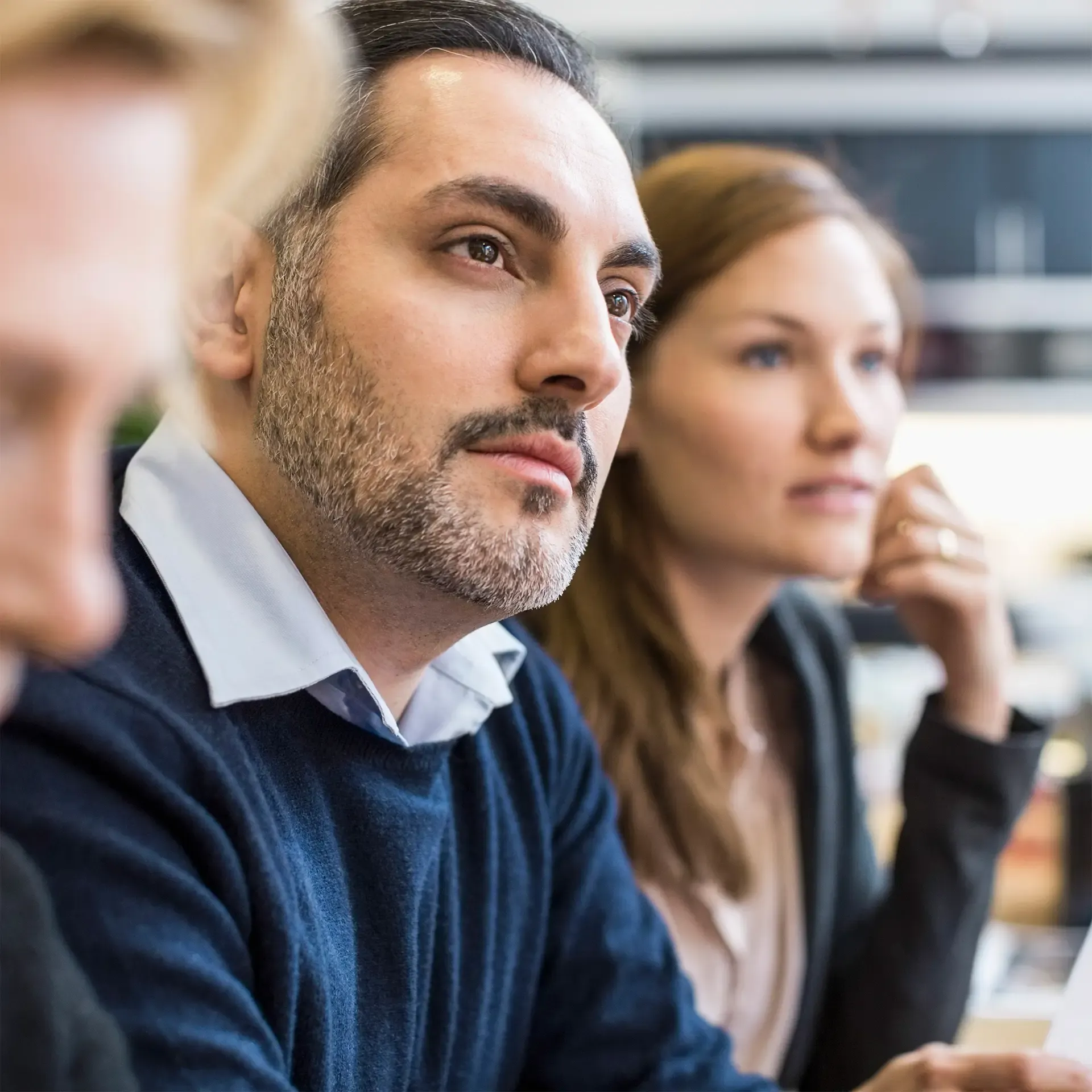 Concentrated businessman looking away in office meeting